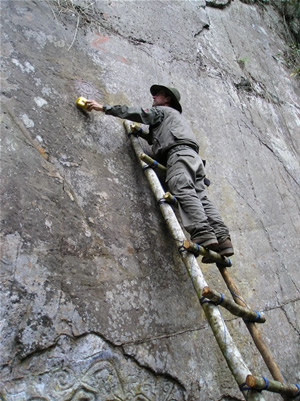 Desde lo alto de una escalera improvisada, Thierry Jamin limpia la parte superior del Sector I-B de Pusharo. (Foto: Thierry Jamin, agosto de 2006)